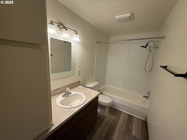 full bathroom featuring shower / bathing tub combination, wood-type flooring, vanity, and toilet