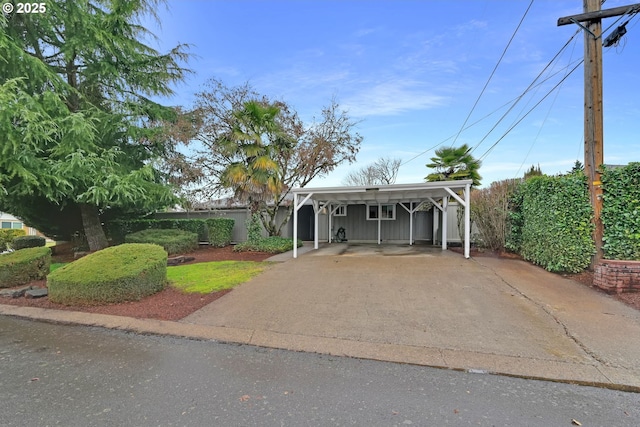 view of front facade with a carport, board and batten siding, and concrete driveway