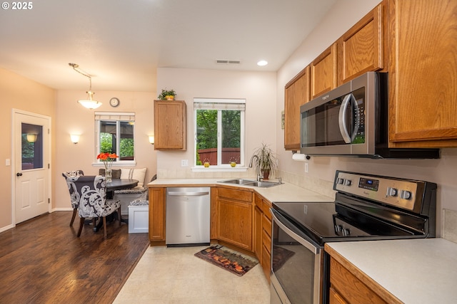 5761 Mt Vernon Rd, Springfield, OR 97478 - kitchen featuring appliances with stainless steel finishes, a sink, brown cabinetry, light countertops, and recessed lighting