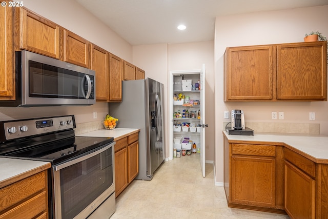 5761 Mt Vernon Rd, Springfield, OR 97478 - kitchen with stainless steel appliances, light countertops, brown cabinets, and recessed lighting