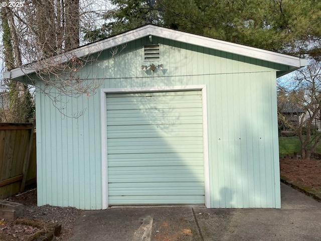 view of outdoor structure with an outbuilding and fence