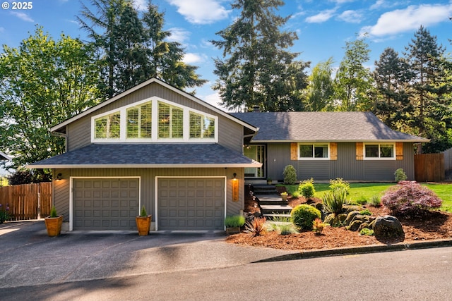 7780 Blinkhorn Way, Gladstone, OR 97027 - split level home featuring a garage, a shingled roof, and asphalt driveway