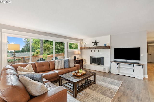 7780 Blinkhorn Way, Gladstone, OR 97027 - living room featuring wood finished floors and a glass covered fireplace