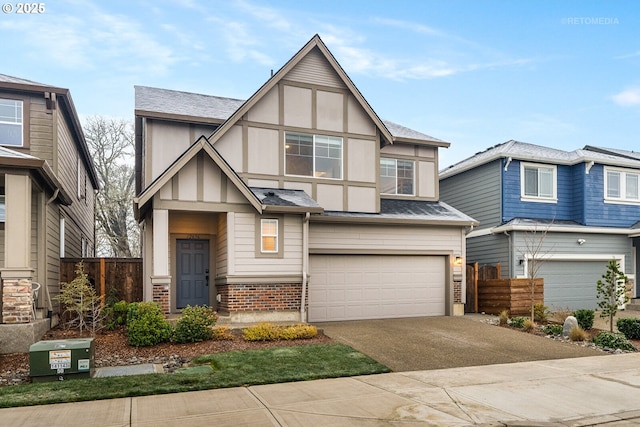 english style home featuring a garage