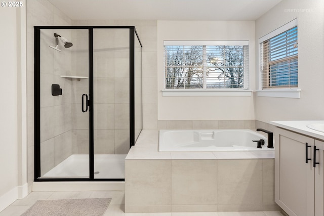 bathroom featuring tile patterned floors, vanity, and independent shower and bath