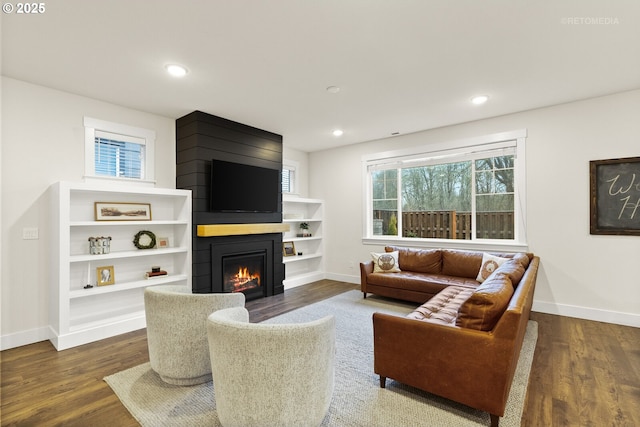 living room featuring dark hardwood / wood-style flooring and a fireplace