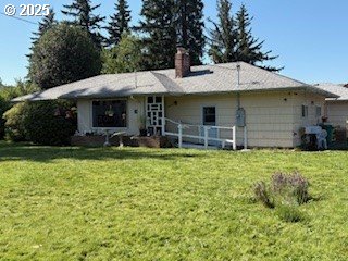 14031 SE Rhone St, Portland, OR 97236 - back of house featuring a lawn and a chimney