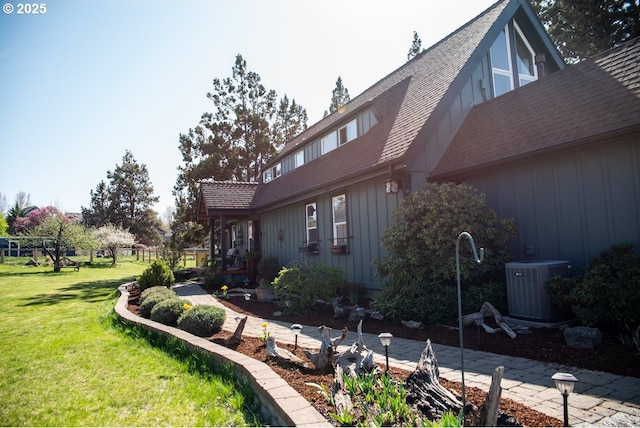 62725 Eagle Rd, Bend, OR 97701 - view of side of home with roof with shingles, central AC, and a yard