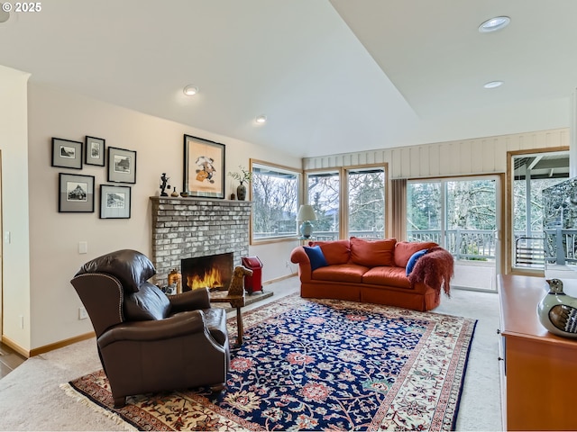 living room with lofted ceiling, recessed lighting, carpet floors, baseboards, and a brick fireplace