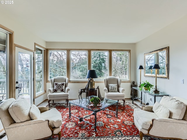 living area featuring a healthy amount of sunlight and baseboards