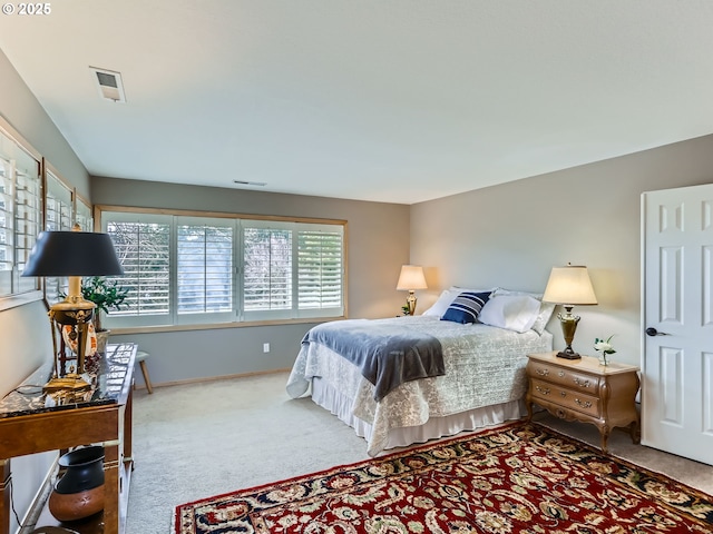 bedroom with carpet floors, visible vents, and baseboards