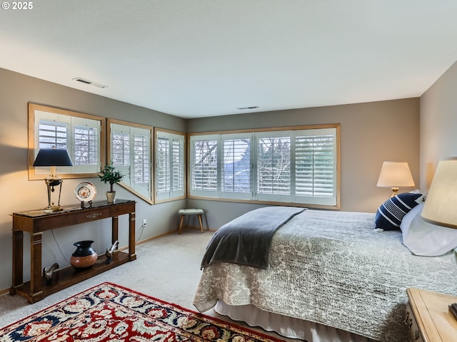 bedroom with carpet, visible vents, and baseboards