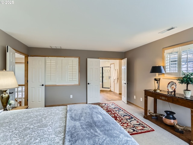 bedroom featuring baseboards, visible vents, light colored carpet, and refrigerator