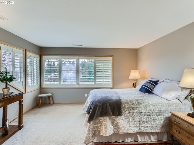 bedroom with carpet flooring, visible vents, and baseboards