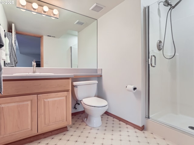 bathroom featuring visible vents, a shower stall, vanity, baseboards, and tile patterned floors