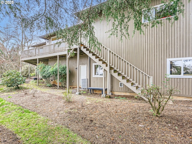 back of property featuring a deck, stairway, and central air condition unit