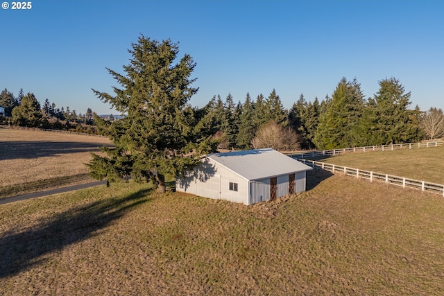 birds eye view of property with a rural view