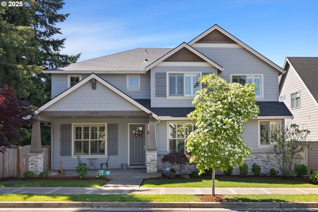 14716 Blue Blossom Way, Oregon City, OR 97045 - craftsman-style house featuring covered porch, stone siding, a shingled roof, and fence