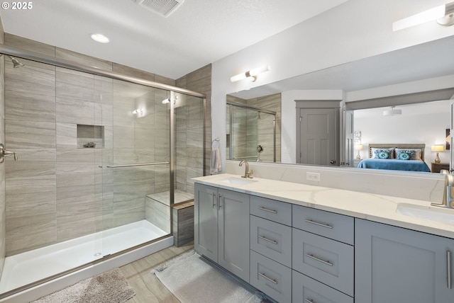 14716 Blue Blossom Way, Oregon City, OR 97045 - ensuite bathroom with double vanity, a shower stall, recessed lighting, and wood finished floors