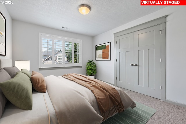 14716 Blue Blossom Way, Oregon City, OR 97045 - bedroom with carpet, a textured ceiling, and a closet