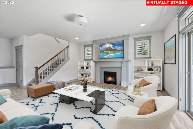 14716 Blue Blossom Way, Oregon City, OR 97045 - living room with wood finished floors, stairs, a brick fireplace, and recessed lighting
