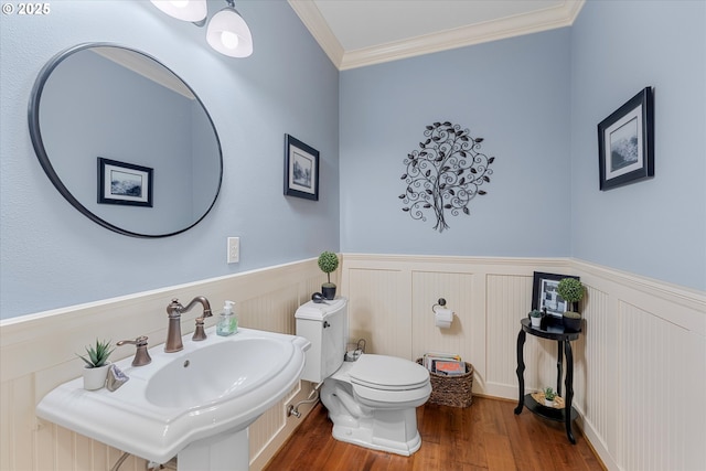 2121 Ostman Rd, West Linn, OR 97068 - bathroom with a wainscoted wall, wood finished floors, toilet, crown molding, and a sink