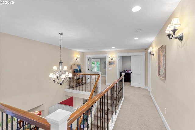 2121 Ostman Rd, West Linn, OR 97068 - hallway featuring an upstairs landing, recessed lighting, light carpet, baseboards, and a chandelier