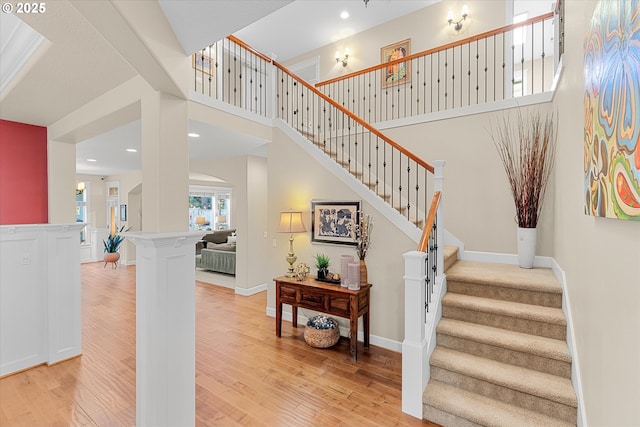 2121 Ostman Rd, West Linn, OR 97068 - stairway featuring wood finished floors, recessed lighting, and a high ceiling