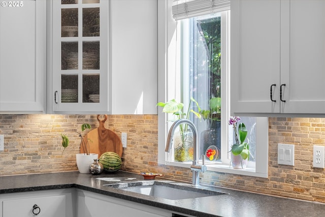 2121 Ostman Rd, West Linn, OR 97068 - kitchen featuring a sink, white cabinetry, glass insert cabinets, and decorative backsplash
