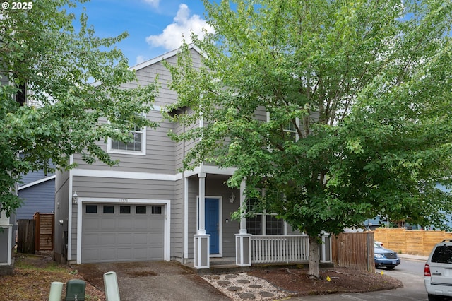 18576 SW Tara Meadows Ct, Beaverton, OR 97078 - obstructed view of property featuring a garage, a porch, and asphalt driveway