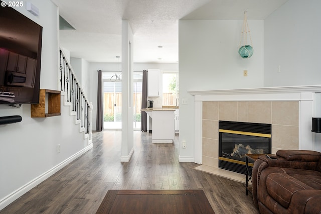 18576 SW Tara Meadows Ct, Beaverton, OR 97078 - living area with dark wood-type flooring, a fireplace, and stairs