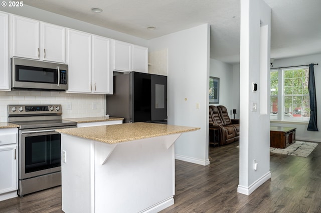 18576 SW Tara Meadows Ct, Beaverton, OR 97078 - kitchen with appliances with stainless steel finishes, dark wood-style floors, tasteful backsplash, and white cabinets