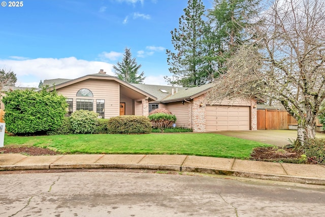 view of front of property featuring a front yard and a garage