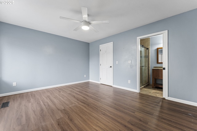 unfurnished bedroom with ensuite bathroom, ceiling fan, dark hardwood / wood-style floors, and a closet