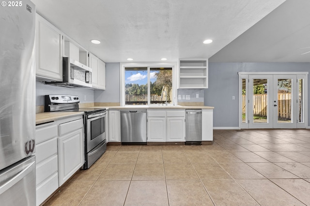 kitchen featuring french doors, white cabinets, sink, light tile patterned floors, and stainless steel appliances