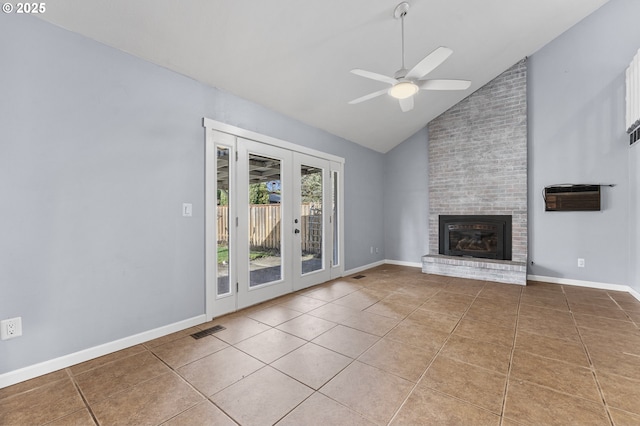 unfurnished living room with tile patterned floors, ceiling fan, a fireplace, and french doors