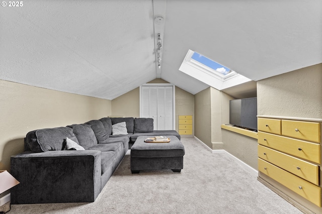 living room with light carpet, rail lighting, and lofted ceiling with skylight