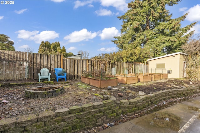 view of yard featuring an outdoor fire pit and a storage unit