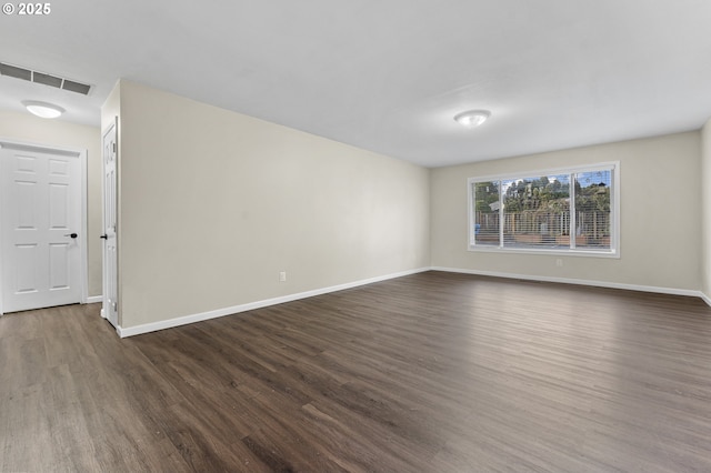 spare room featuring dark wood-type flooring