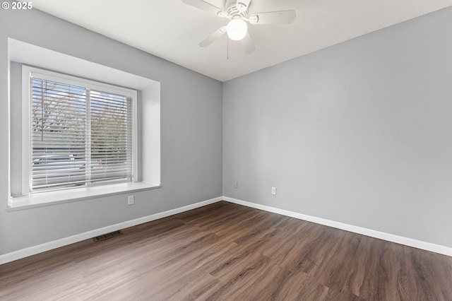 spare room with ceiling fan and hardwood / wood-style flooring