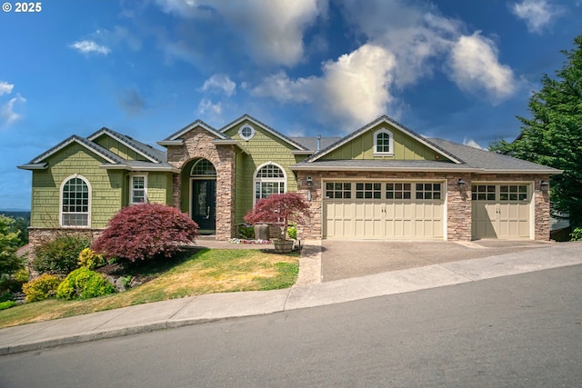 8512 SE Constance Dr, Happy Valley, OR 97086 - view of front of home featuring a garage, stone siding, and driveway