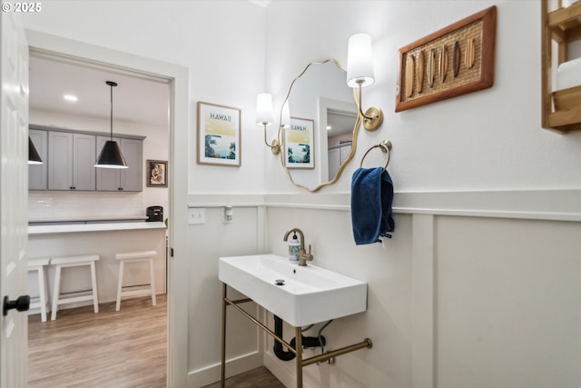 bathroom featuring decorative backsplash and wood finished floors