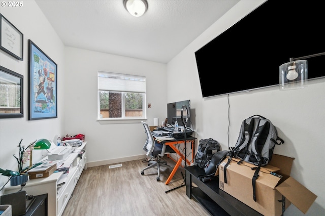 office area featuring light wood-style floors and baseboards