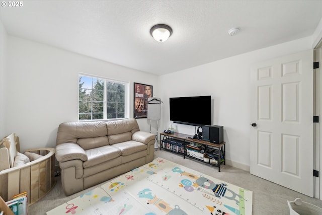 living area with light colored carpet, a textured ceiling, and baseboards