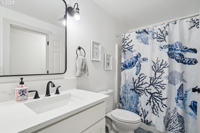 bathroom with curtained shower, vanity, and toilet