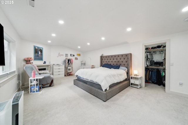 bedroom with recessed lighting, a closet, light carpet, and vaulted ceiling