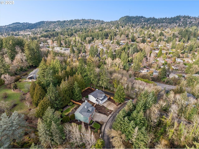 drone / aerial view featuring a wooded view