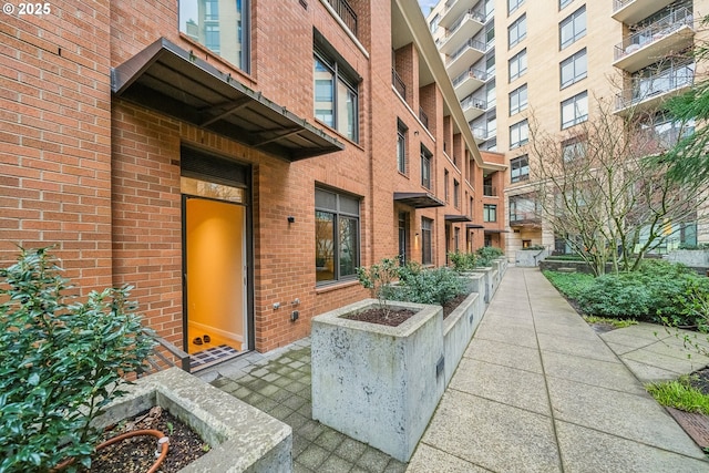 property entrance with brick siding