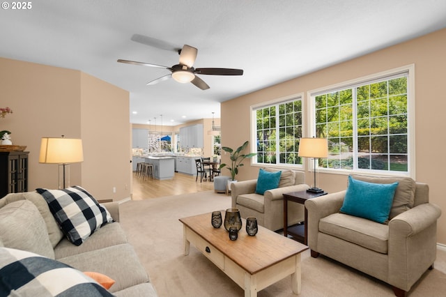 342 NW 84th Pl, Portland, OR 97229 - living room featuring a ceiling fan, light carpet, baseboards, recessed lighting, and light wood finished floors