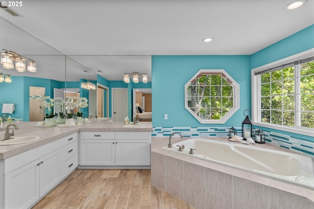342 NW 84th Pl, Portland, OR 97229 - full bath featuring a garden tub, wood finished floors, double vanity, and recessed lighting